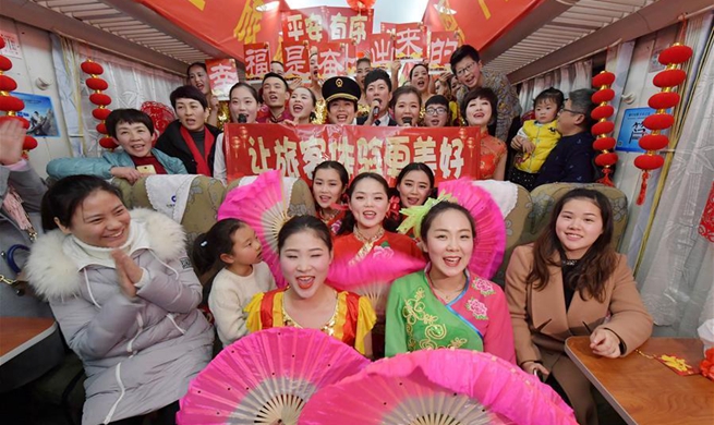 Attendants perform for passengers on train to celebrate Spring Festival